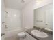 Modern bathroom with gray countertops, white cabinets, and a bathtub at 24449 Nw Falcon Ave, Dunnellon, FL 34431
