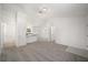 Open living room with grey carpet, kitchen, and bathroom access at 24449 Nw Falcon Ave, Dunnellon, FL 34431
