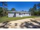 House exterior view, gray siding and large backyard at 24449 Nw Falcon Ave, Dunnellon, FL 34431