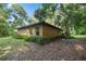 House exterior with stucco siding, green landscaping and a side view at 7679 S Magnolia Ave, Ocala, FL 34476