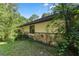 House exterior with stone accents, green landscaping, and mature trees at 7679 S Magnolia Ave, Ocala, FL 34476
