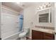 Clean bathroom with shower/tub combo and granite vanity at 7679 S Magnolia Ave, Ocala, FL 34476