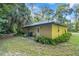 House exterior with stucco siding, green landscaping and a side view at 7679 S Magnolia Ave, Ocala, FL 34476