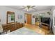 Spacious bedroom with dresser, TV, and access to bathroom at 7679 S Magnolia Ave, Ocala, FL 34476