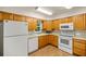 Well-equipped kitchen with light wood cabinets, modern appliances, and tile flooring at 7679 S Magnolia Ave, Ocala, FL 34476