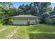 Two-car garage with stone accents and a metal roof at 7679 S Magnolia Ave, Ocala, FL 34476