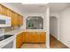 Open kitchen with light wood cabinets, granite countertops, and a view of the living area at 7679 S Magnolia Ave, Ocala, FL 34476
