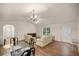 Bright and airy living room with hardwood floors and access to the kitchen and a bedroom at 7679 S Magnolia Ave, Ocala, FL 34476