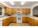 Modern kitchen with light wood cabinets, ample counter space, and tile flooring at 7679 S Magnolia Ave, Ocala, FL 34476