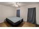 Comfortable bedroom with a ceiling fan, wood floors, and large closet at 7679 S Magnolia Ave, Ocala, FL 34476