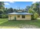 View of the house's rear, showcasing a simple design and metal roof at 7679 S Magnolia Ave, Ocala, FL 34476