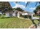 House exterior with lush green lawn and flag at 9500 Sw 93Rd Loop, Ocala, FL 34481