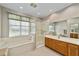 Elegant bathroom with a double vanity, soaking tub, and walk-in shower at 9500 Sw 93Rd Loop, Ocala, FL 34481