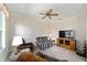Living room features plush seating, a large TV, and a ceiling fan at 9500 Sw 93Rd Loop, Ocala, FL 34481