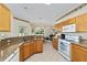 Galley kitchen with granite countertops and wood cabinets at 9500 Sw 93Rd Loop, Ocala, FL 34481