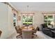 Bright dining area with wood table and chairs, overlooking a garden at 9500 Sw 93Rd Loop, Ocala, FL 34481