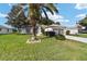 Home exterior view, showcasing landscaping and palm tree at 9500 Sw 93Rd Loop, Ocala, FL 34481