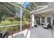 Relaxing screened porch with view of backyard and lush landscaping at 9500 Sw 93Rd Loop, Ocala, FL 34481