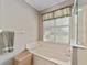 Clean bathroom with a bathtub and window providing natural light at 9500 Sw 93Rd Loop, Ocala, FL 34481