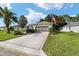 Single-story house with gray garage doors and American flag at 9500 Sw 93Rd Loop, Ocala, FL 34481