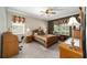 Spacious bedroom with wooden furniture and ample natural light at 9500 Sw 93Rd Loop, Ocala, FL 34481