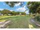 Landscaped backyard with lush green grass and mature trees at 9500 Sw 93Rd Loop, Ocala, FL 34481