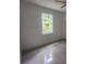 Bright bedroom with large window and light grey flooring at 13260 Se 33Rd Ct, Belleview, FL 34420
