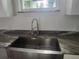 Modern farmhouse sink and granite countertop in the kitchen at 13260 Se 33Rd Ct, Belleview, FL 34420