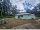 Back of the house showcasing a covered patio and undeveloped lot at 13260 Se 33Rd Ct, Belleview, FL 34420