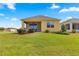 House exterior showcasing a screened porch and landscaping at 9818 Sw 99Th Loop, Ocala, FL 34481