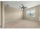 Spacious bedroom with ceiling fan and carpeted floors at 9818 Sw 99Th Loop, Ocala, FL 34481
