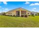 Backyard view of a single-story house with screened patio at 9818 Sw 99Th Loop, Ocala, FL 34481