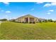 Backyard view of a single-story house with screened patio at 9818 Sw 99Th Loop, Ocala, FL 34481