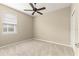 Spacious bedroom with ceiling fan and carpet flooring at 9818 Sw 99Th Loop, Ocala, FL 34481