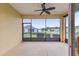 A screened porch with ceiling fan, and view of backyard at 9818 Sw 99Th Loop, Ocala, FL 34481