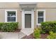 House entrance with a dark brown door and flanking bushes at 4230 Sw 50Th Cir, Ocala, FL 34474