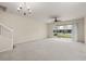 Spacious living room with a ceiling fan, chandelier, and access to a patio at 4230 Sw 50Th Cir, Ocala, FL 34474