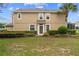 Tan two-story house with landscaping, and a screened patio at 4230 Sw 50Th Cir, Ocala, FL 34474