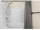 Bathroom with tub shower combo, gray curtain, and built-in shelving at 4230 Sw 50Th Cir, Ocala, FL 34474