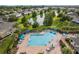 Community pool with plenty of lounge chairs and umbrellas at 4230 Sw 50Th Cir, Ocala, FL 34474