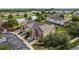 Aerial view showcasing townhouses, a lake, and lush green landscaping at 4230 Sw 50Th Cir, Ocala, FL 34474