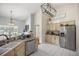 Kitchen boasts granite countertops, ample cabinetry, and stainless steel appliances at 13783 Se 8Th Ct, Ocala, FL 34480