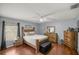 Bedroom featuring wood floors and ceiling fan at 13783 Se 8Th Ct, Ocala, FL 34480
