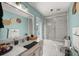 Light teal bathroom with tub/shower combo and updated vanity at 13783 Se 8Th Ct, Ocala, FL 34480