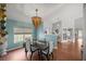 Elegant dining room features a dark wood table and chandelier at 13783 Se 8Th Ct, Ocala, FL 34480