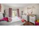 Cozy bedroom with a white bed and pink accents at 13783 Se 8Th Ct, Ocala, FL 34480
