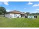 Spacious backyard with green grass and a view of the pool at 13783 Se 8Th Ct, Ocala, FL 34480