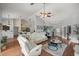 Open living room showcasing a sectional sofa and kitchen view at 13783 Se 8Th Ct, Ocala, FL 34480
