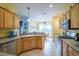 Spacious kitchen with light wood cabinets, ample counter space, and stainless steel appliances at 8655 Sw 86Th Cir, Ocala, FL 34481