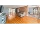 Open living space with hardwood floors, exposed brick, and views to dining area at 2305 Se 8Th St, Ocala, FL 34471